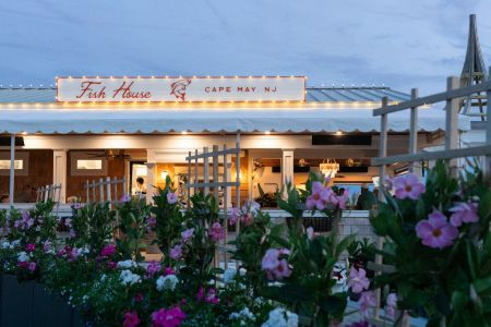 Fish House in early evening with exterior lights on