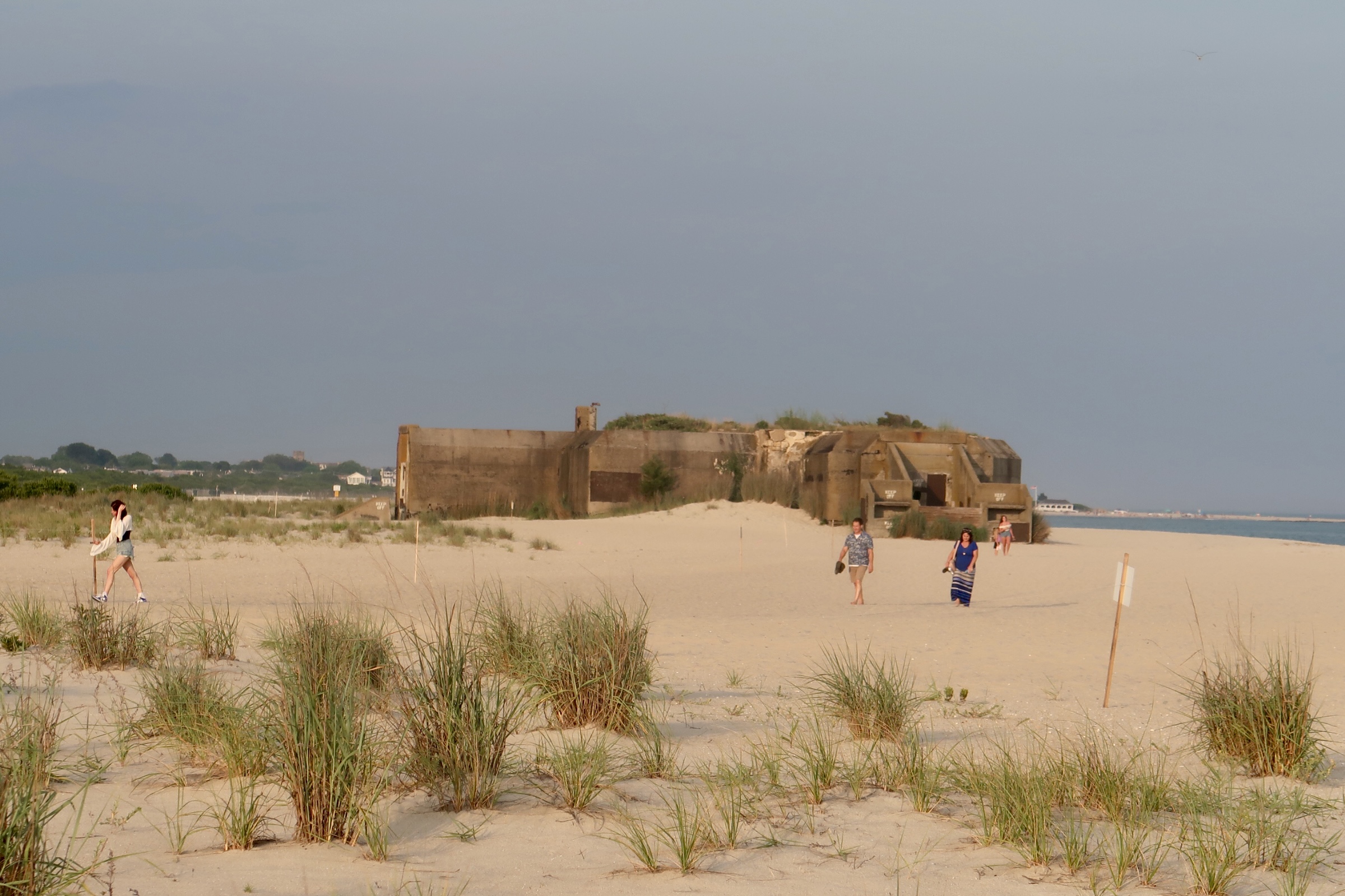 Cape May bunker and people walking on the beach