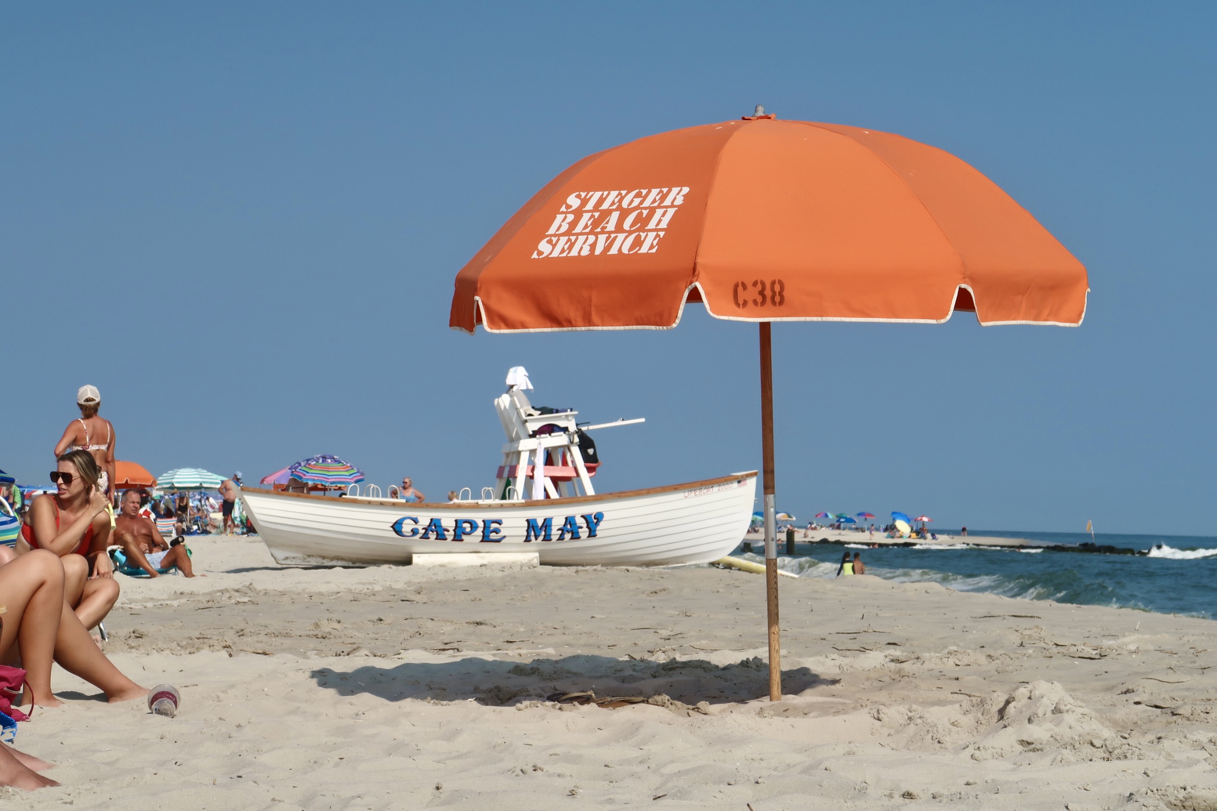 Steger Beach Service umbrella in foreground , life boat in background on the beach