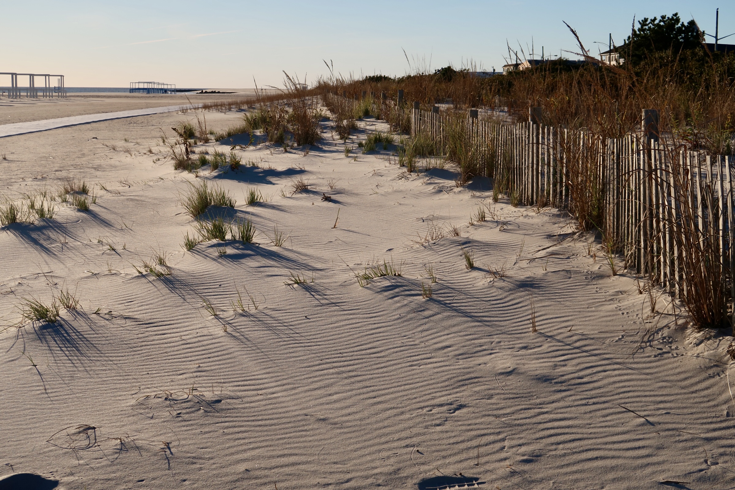 Lowering sun casts shadow on sand in dunes