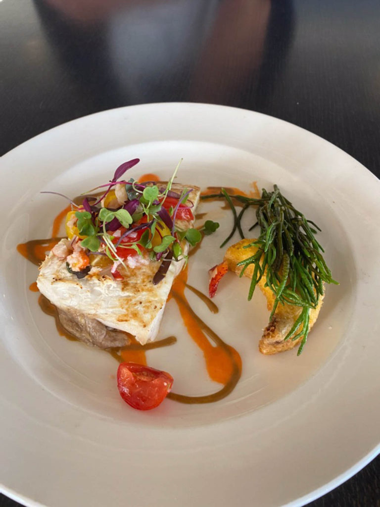 Pan seared halibut black garlic polenta baby heirloom tomatoes and lobster salad sherry vinegar and tomato emulsions