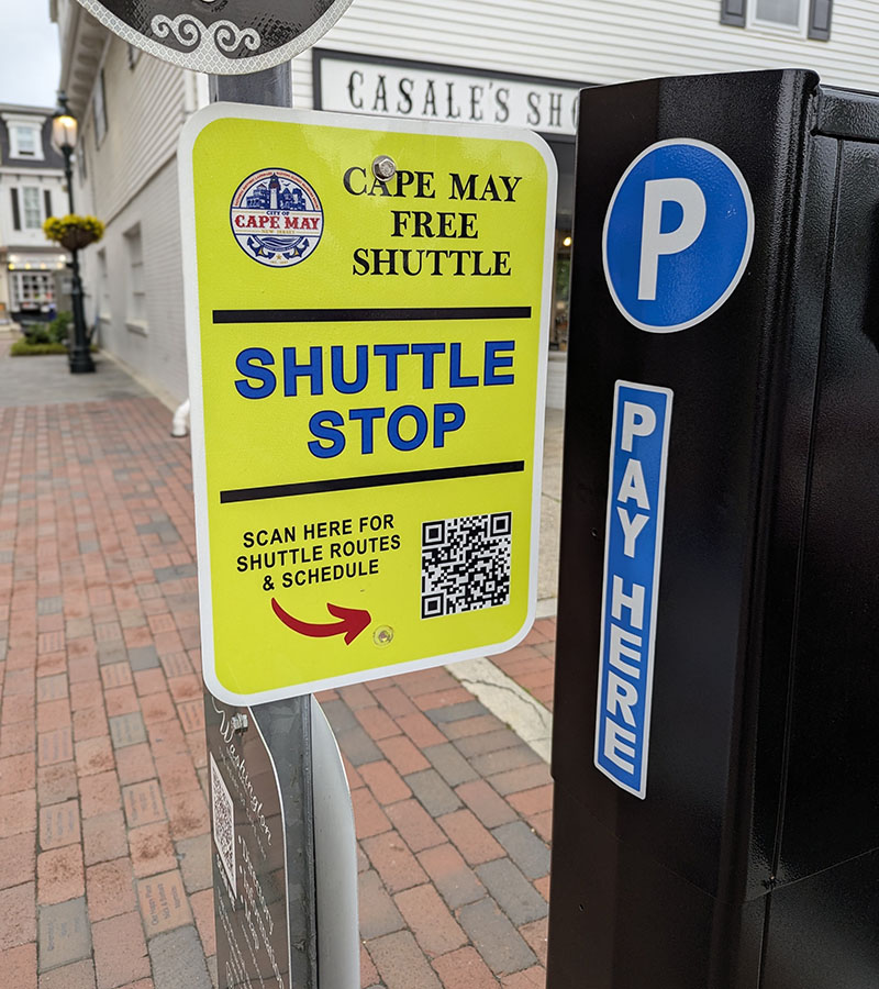 Yellow shuttle stop sign behind the Washington Street Mall
